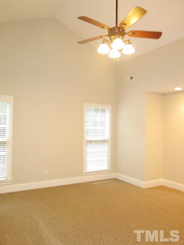 7617 Harps Mill Road Raleigh, NC 27615 - Photo 9 of 24 an empty room with windows and fan