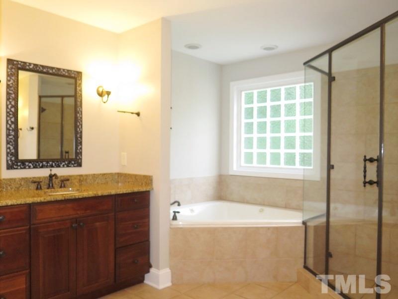 7617 Harps Mill Road Raleigh, NC 27615 - Photo 10 of 24 a bathroom with a granite countertop tub sink and mirror