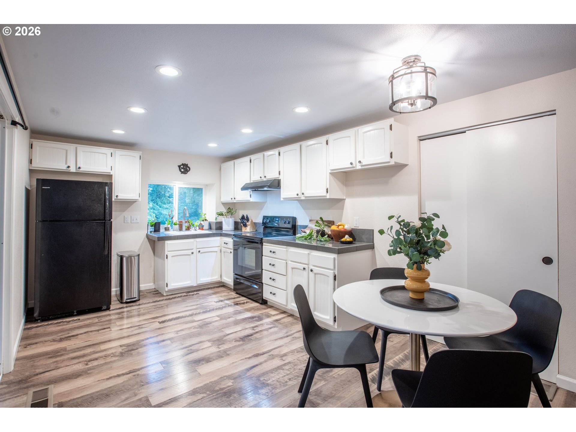 4721 Southwest 45th Avenue Portland, OR 97221 - Photo 14 of 29 a kitchen with a table and chairs in it