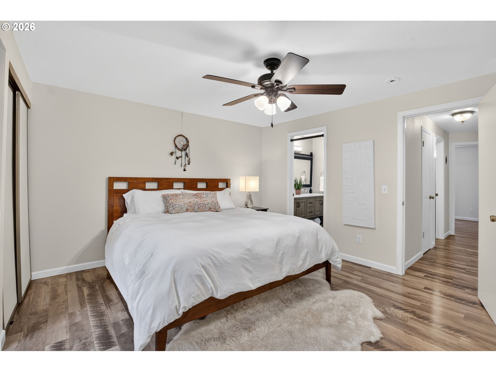 4721 Southwest 45th Avenue Portland, OR 97221 - Photo 17 of 29 a bedroom with a bed and a chandelier