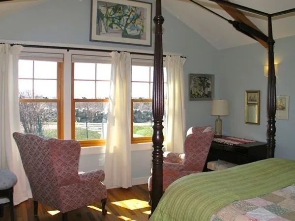 a bedroom with a bed and glass window