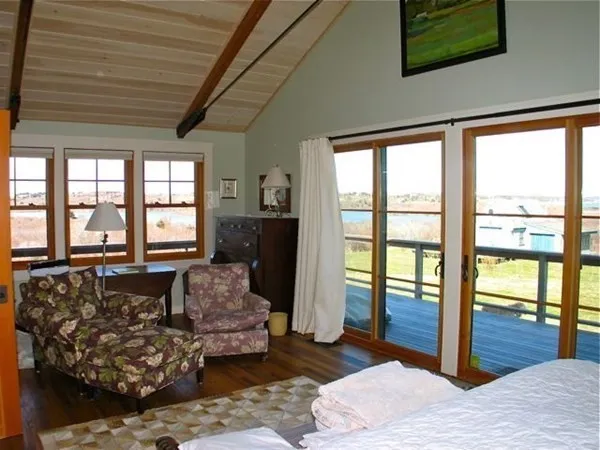 a living room with furniture and large windows