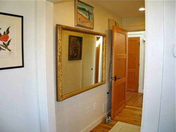 a view of a hallway with wooden floor
