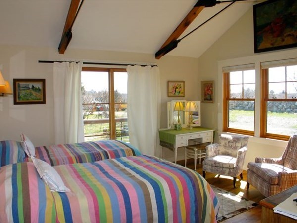 17 Round Pond Road Chilmark, MA 02535 - Photo 17 of 39 a bedroom with a bed and a flat screen tv