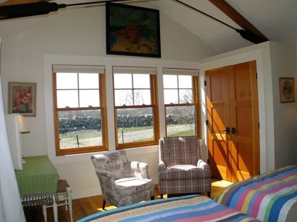 a living room with furniture and a floor to ceiling window