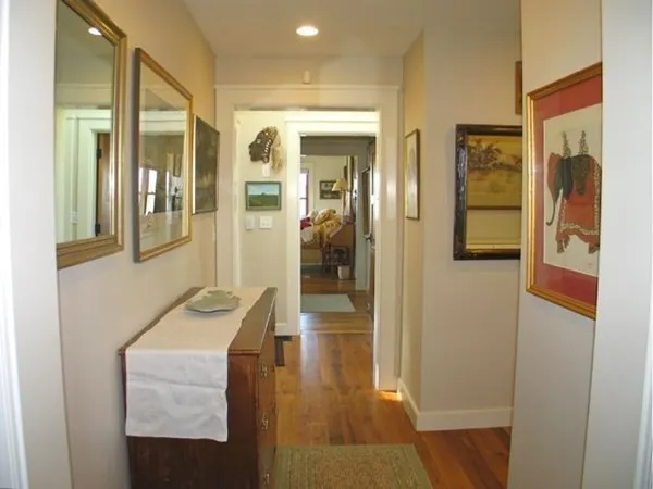 a room with a cabinet and a painting on the wall