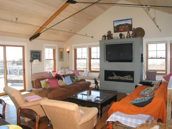 a living room with furniture a fireplace and a flat screen tv