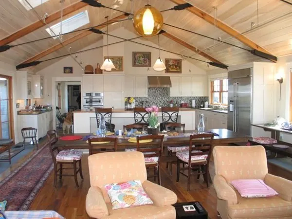a living room with lots of furniture and kitchen view