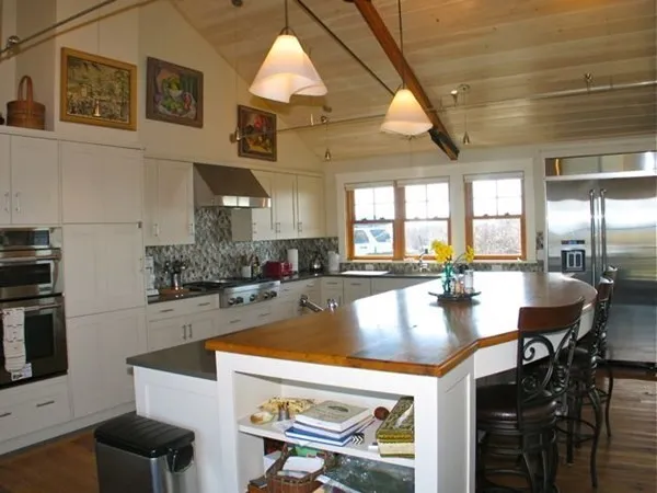 a large kitchen with a table and chairs