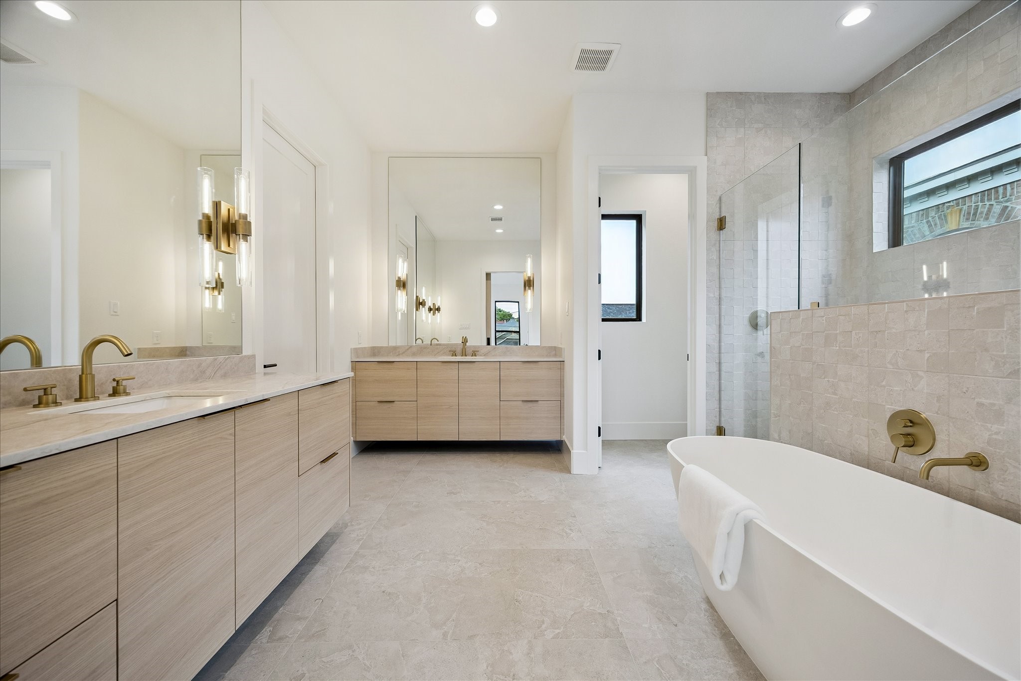 122 East 4th Street Houston, TX 77007 - Photo 21 of 38 Primary bath – features floating double vanities, a freestanding tub, and a frameless glass walk-in shower.
