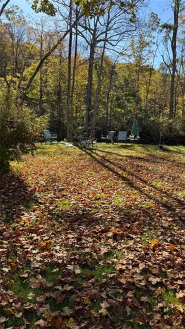 a view of a big yard with an outdoor space and seating area