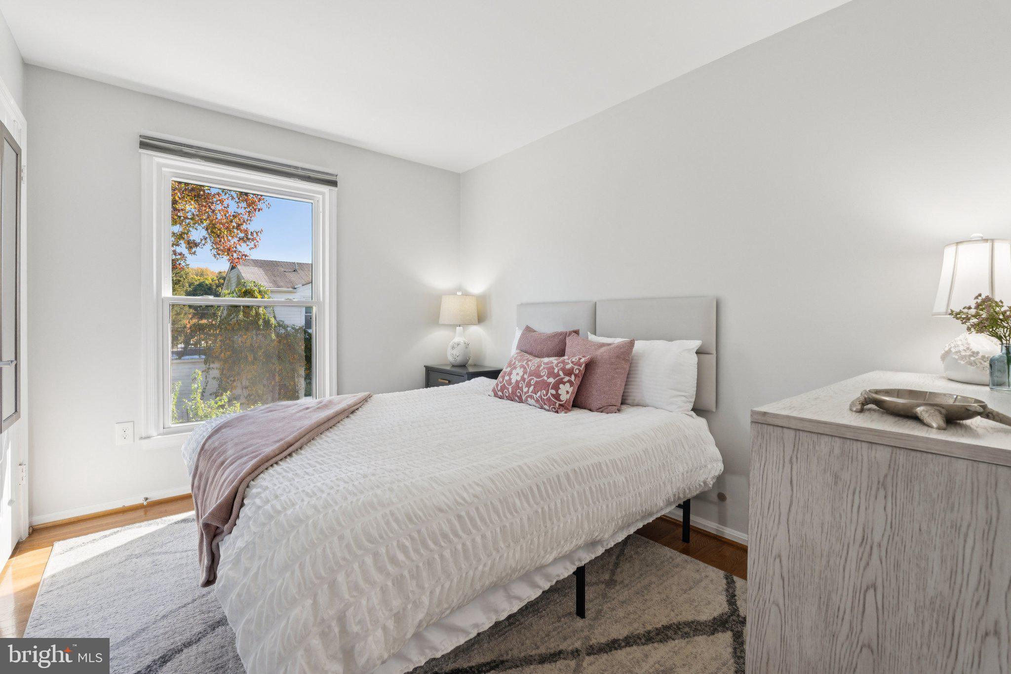 8518 Riverside Road Alexandria, VA 22308 - Photo 11 of 34 a bedroom with a bed and wooden floor