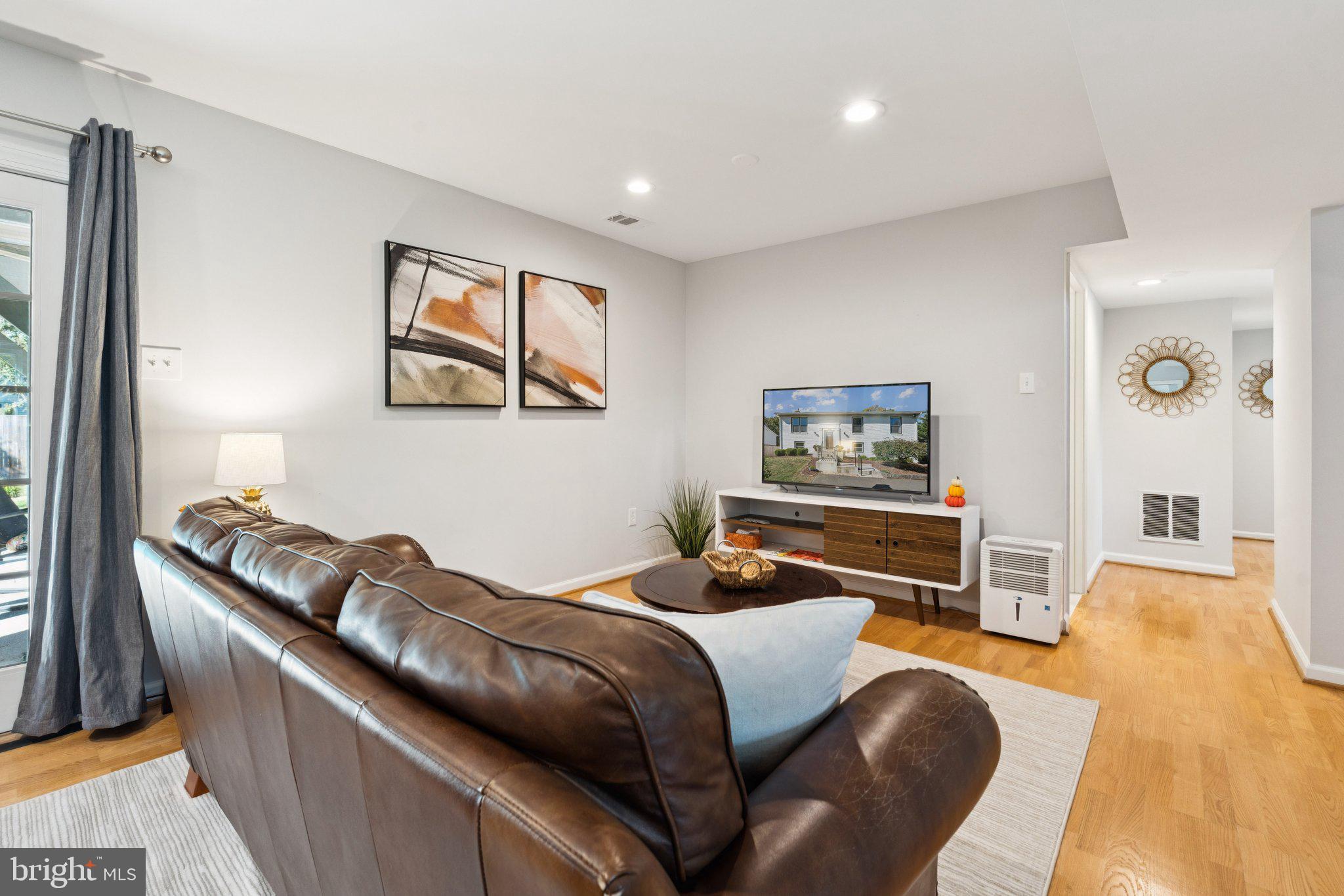 8518 Riverside Road Alexandria, VA 22308 - Photo 19 of 34 a bedroom with a bed and wooden floor