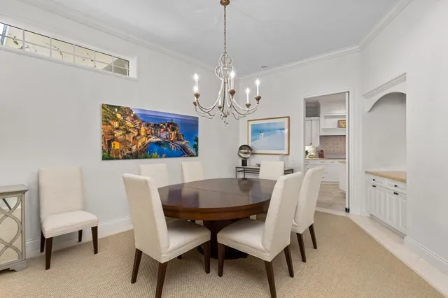 a dining room with furniture a rug and a chandelier