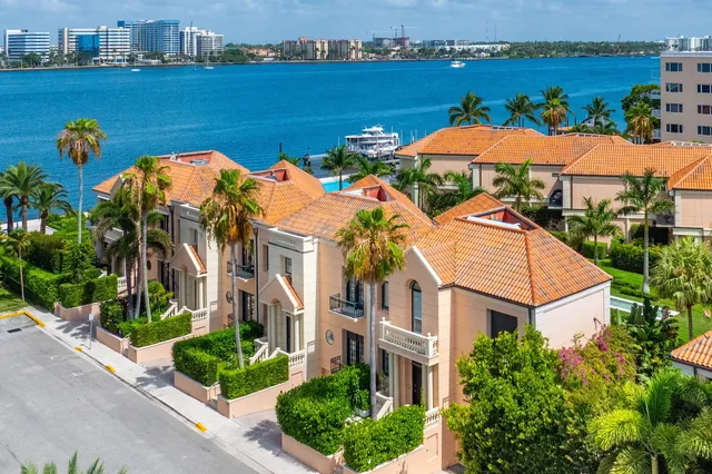 an aerial view of residential houses with outdoor space and river