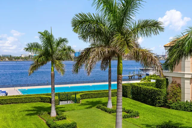 a spacious bathroom with a granite countertop sink a mirror a bathtub and a shower