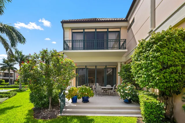 a view of a house with sitting area and garden