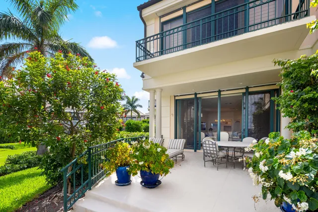 a view of a patio with table and chairs and potted plants