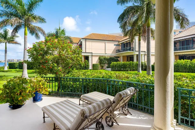 a view of a chair and table in the back yard of the house