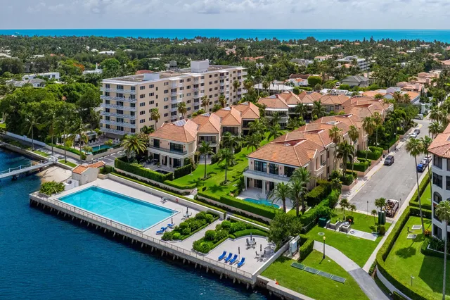 an aerial view of a city with lots of residential buildings lake and ocean view