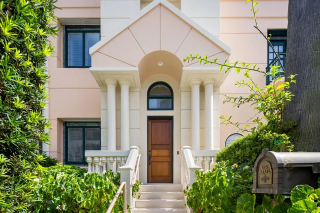 a front view of a house with a garden