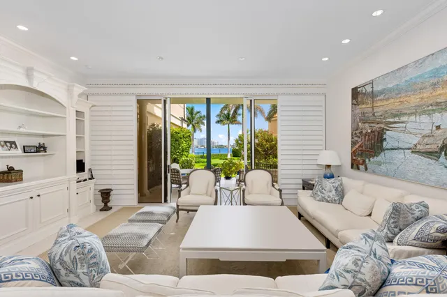 a living room with furniture and large windows
