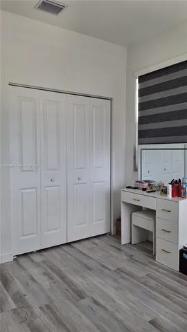 a view of kitchen with cabinets and wooden floor