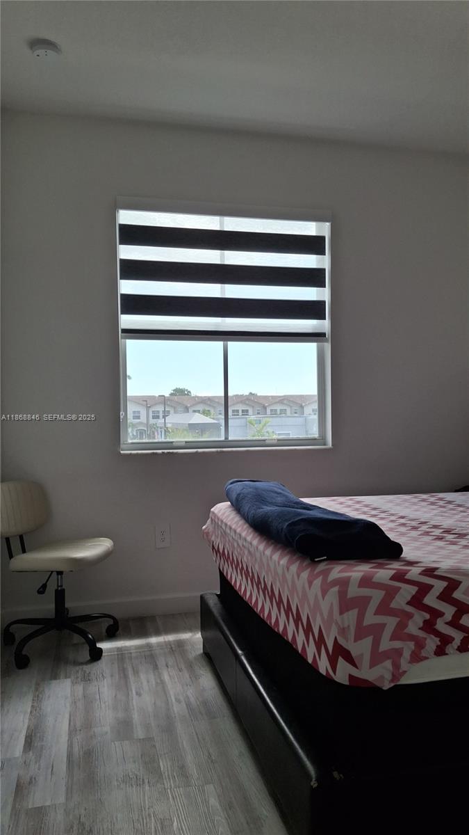 26410 Southwest 148th Court Homestead, FL 33032 - Photo 16 of 42 a bedroom with a bed and a window