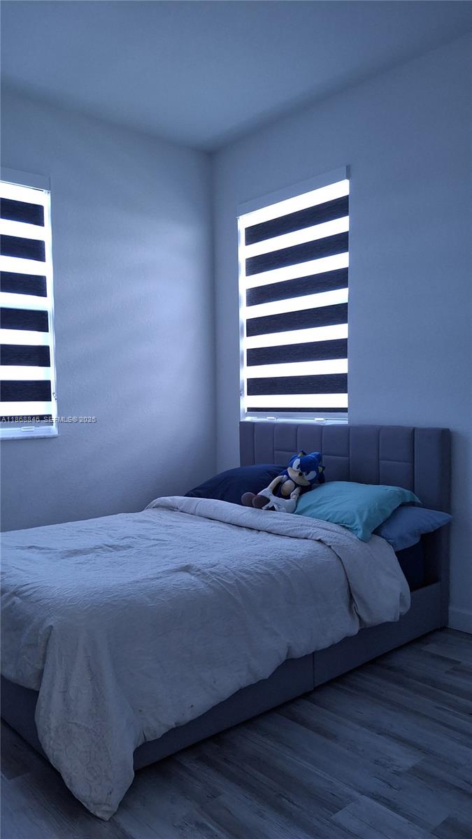 26410 Southwest 148th Court Homestead, FL 33032 - Photo 23 of 42 a bedroom with a bed and a window