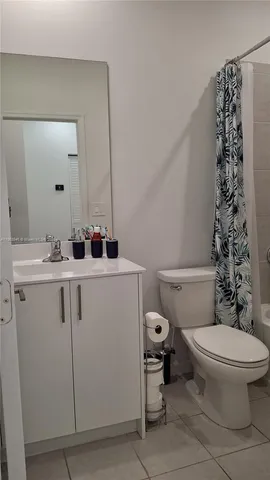 a bathroom with a sink toilet and mirror