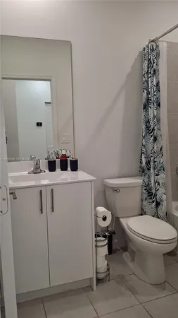 a bathroom with a sink toilet and mirror