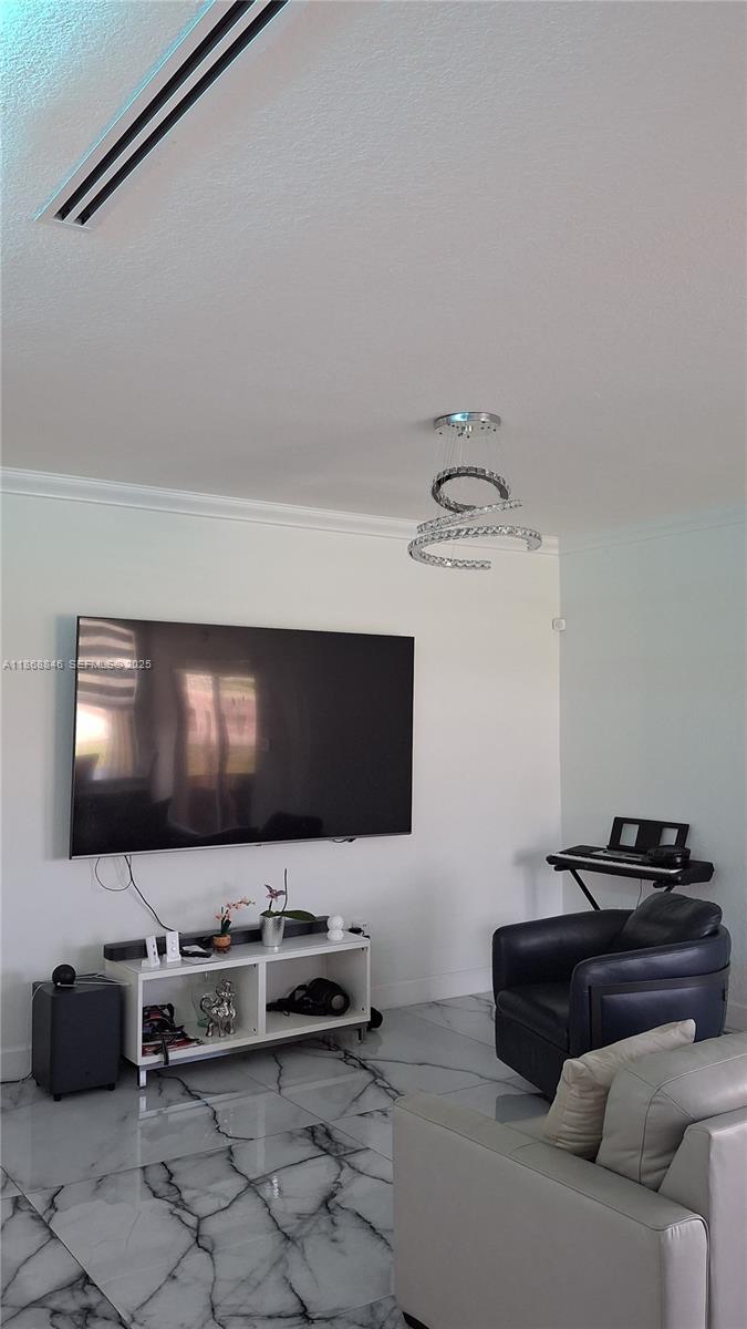 26410 Southwest 148th Court Homestead, FL 33032 - Photo 3 of 42 a living room with furniture and a flat screen tv