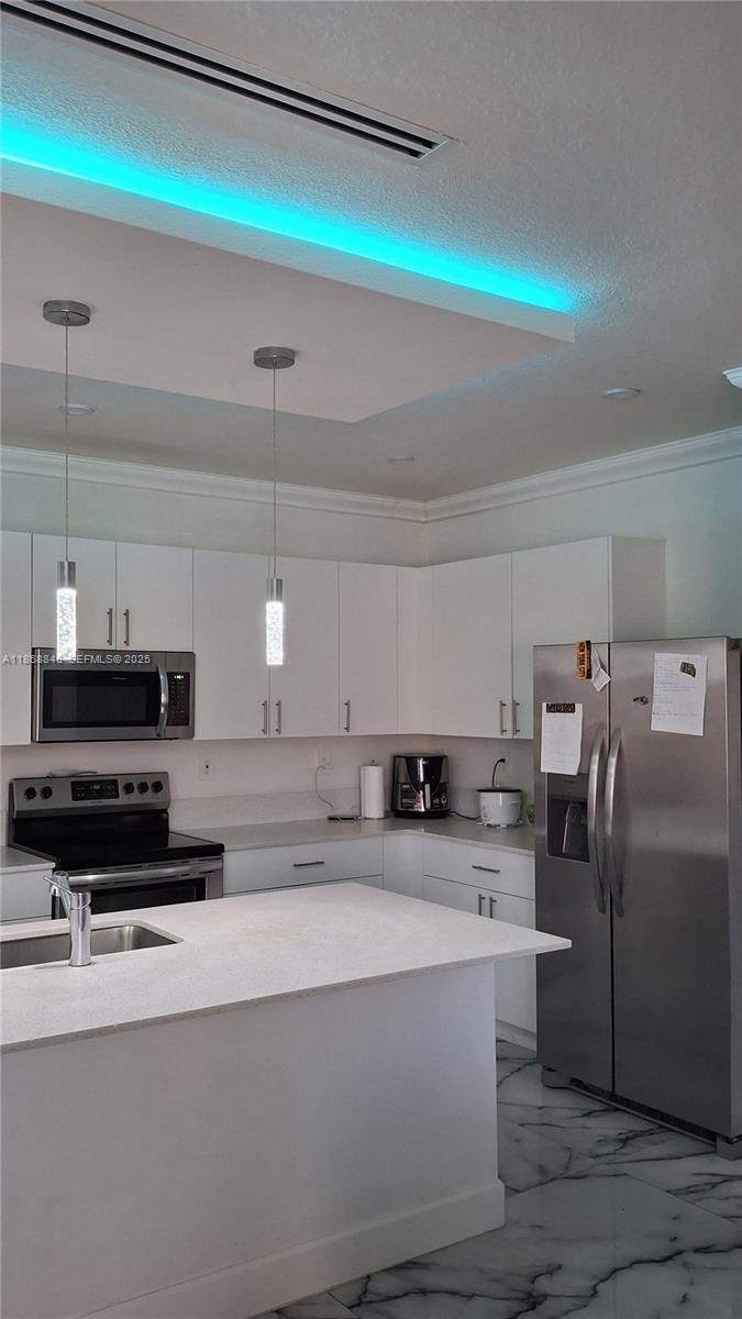 26410 Southwest 148th Court Homestead, FL 33032 - Photo 32 of 42 a kitchen with stainless steel appliances a refrigerator a stove a sink and a stove