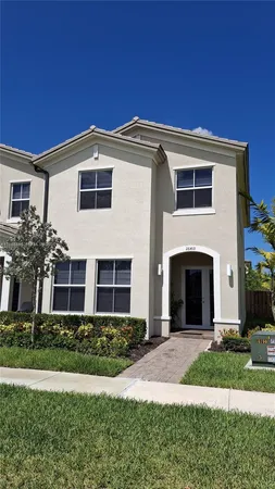 a bedroom with a bed and a lamp