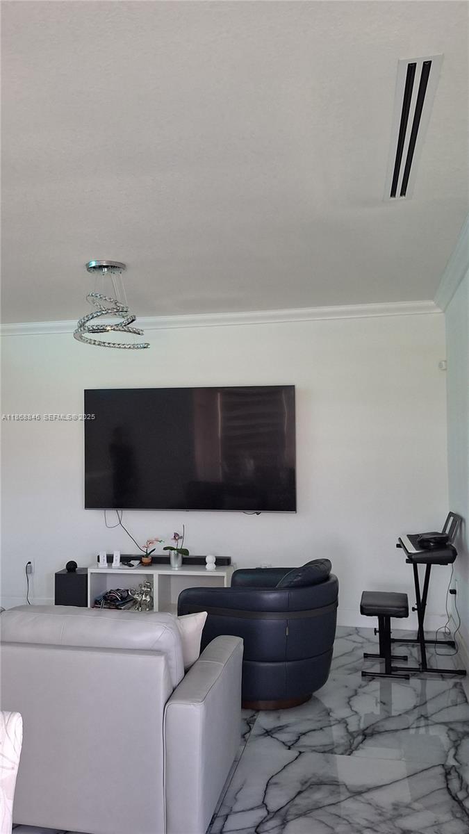 26410 Southwest 148th Court Homestead, FL 33032 - Photo 6 of 42 a living room with furniture and a flat screen tv