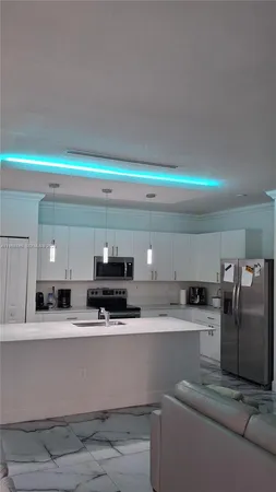 a kitchen with stainless steel appliances granite countertop a sink and a stove top oven with granite countertops