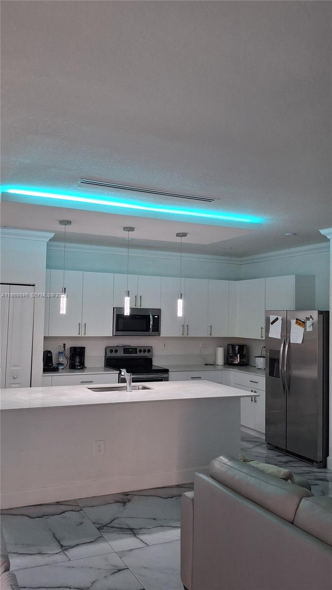 26410 Southwest 148th Court Homestead, FL 33032 - Photo 8 of 42 a kitchen with stainless steel appliances granite countertop a sink and a stove top oven with granite countertops