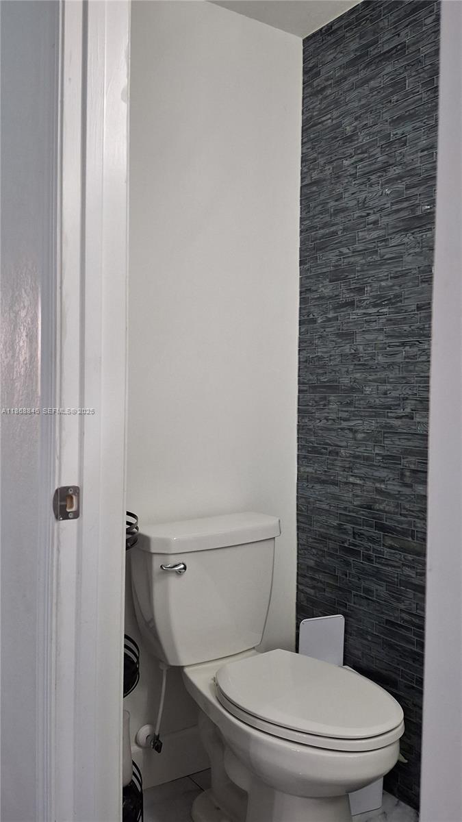 26410 Southwest 148th Court Homestead, FL 33032 - Photo 9 of 42 a white toilet sitting next to a shower