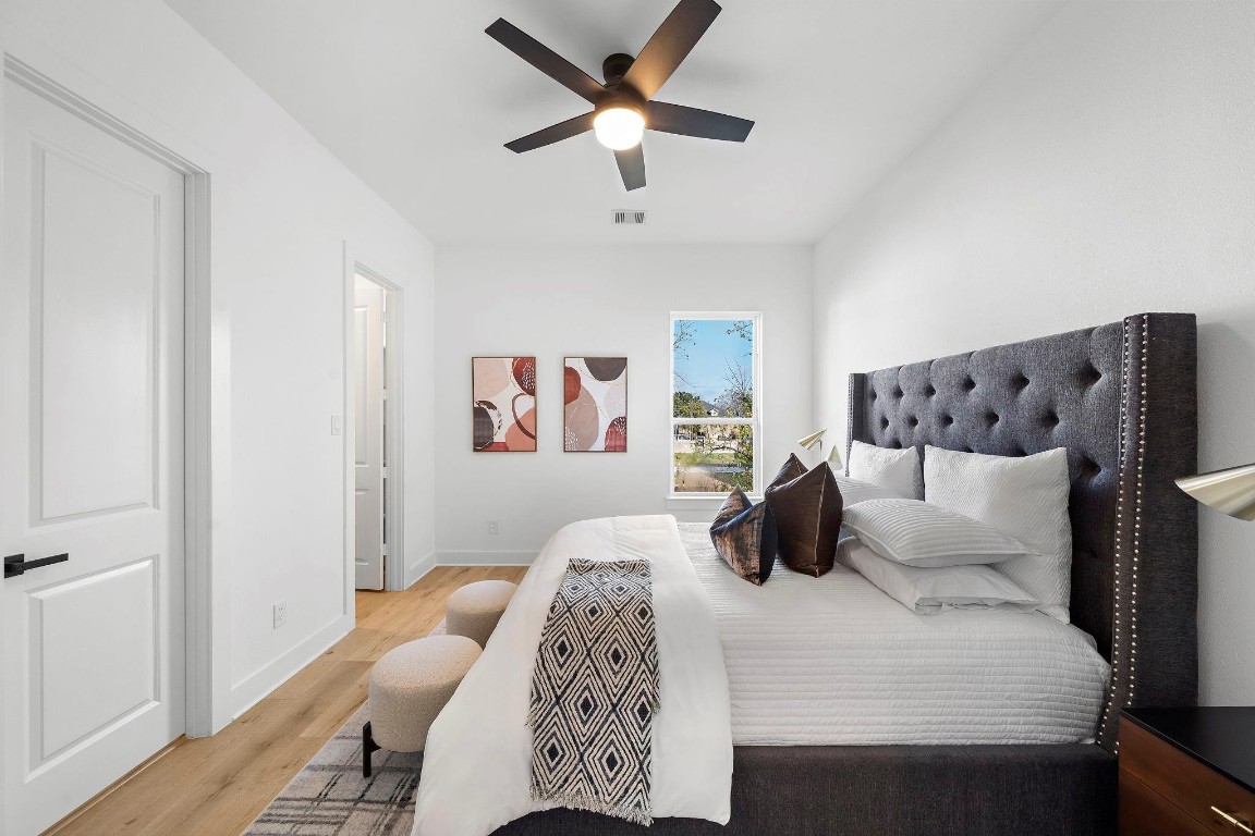 309 East 43rd Street Houston, TX 77022 - Photo 13 of 17 a bedroom with a large bed and a chandelier