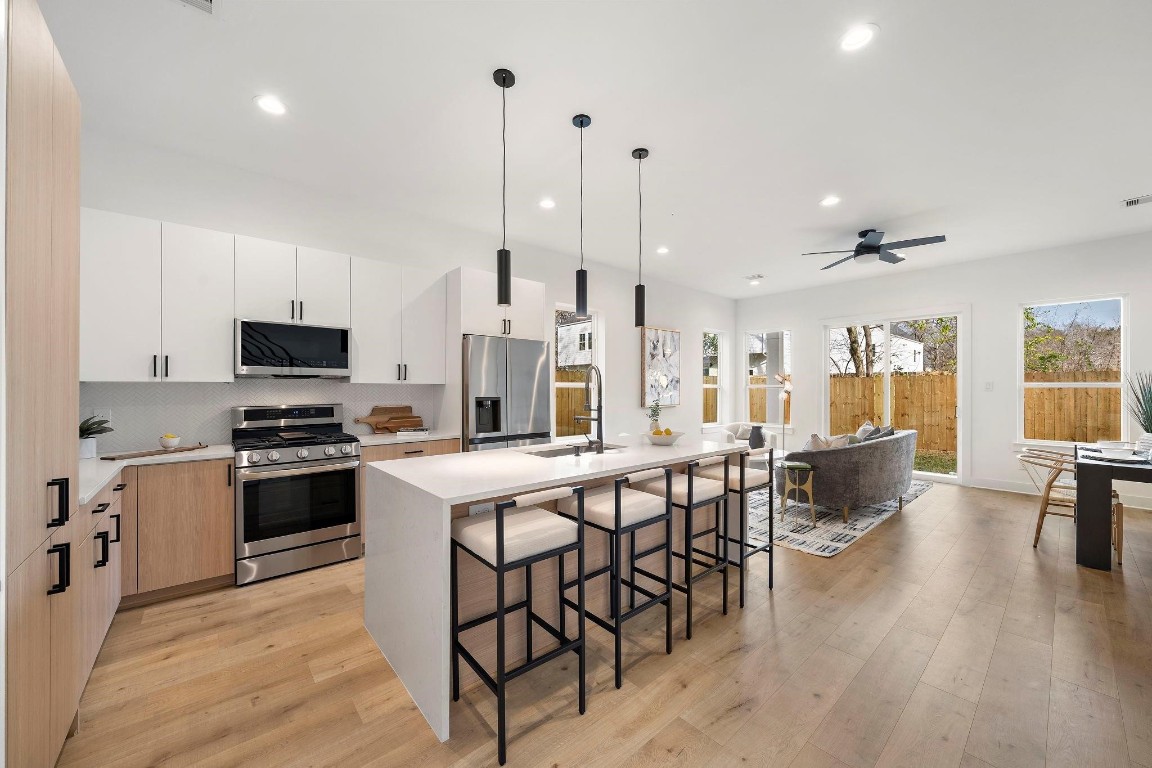 309 East 43rd Street Houston, TX 77022 - Photo 4 of 17 a large kitchen with stainless steel appliances kitchen island granite countertop a large island in the center