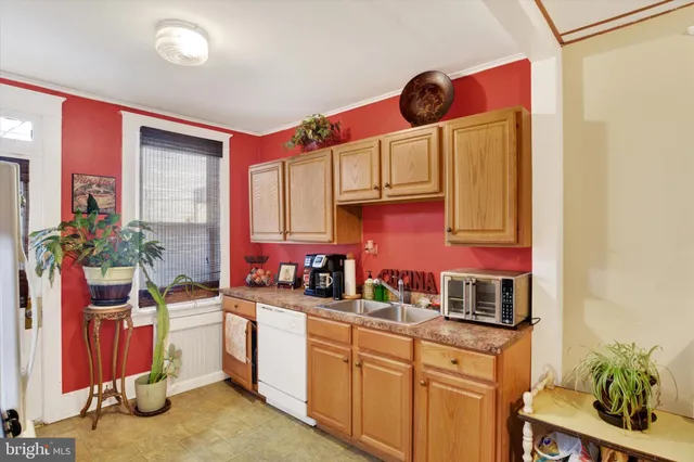 a kitchen with a sink cabinets and window