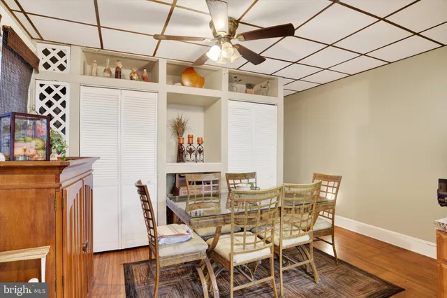 a dining room with furniture and wooden floor