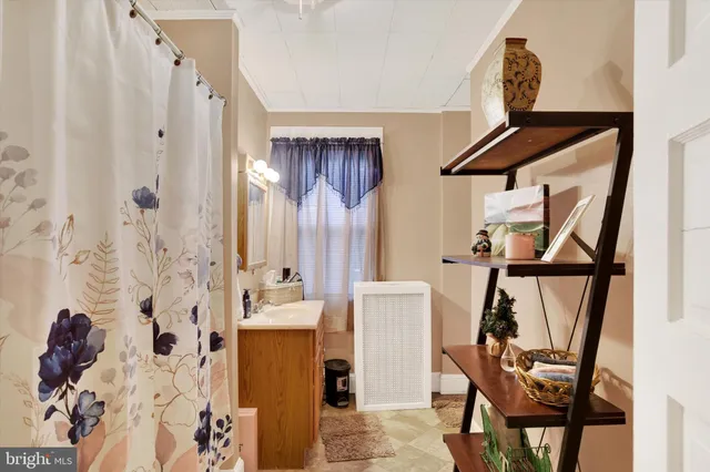 a bathroom with a window and a shower