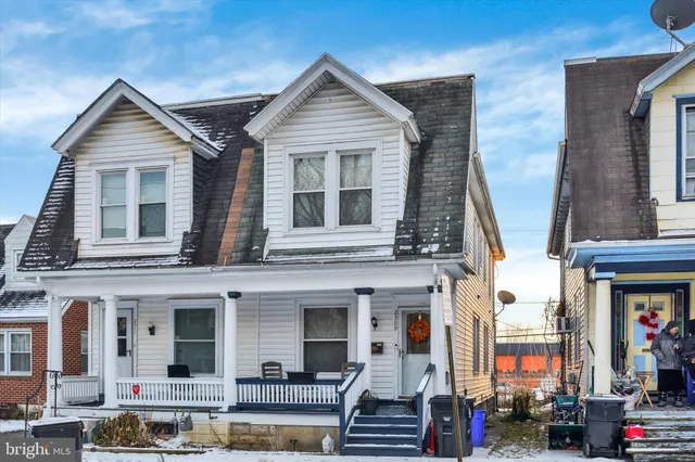 a front view of a residential apartment building with glass windows