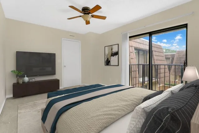 a bedroom with a large bed and a flat tv screen