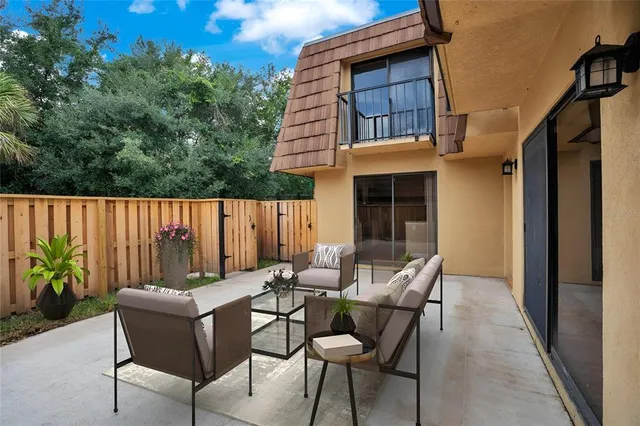 a backyard of a house with table and chairs