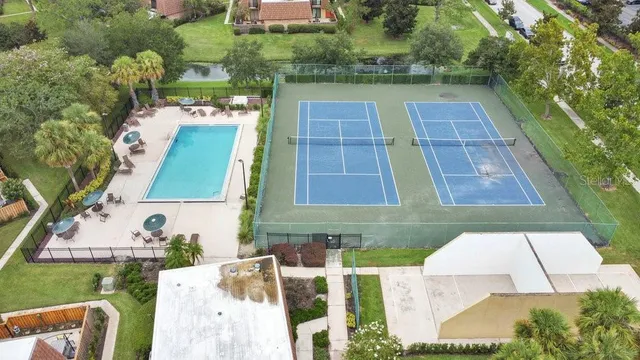 an aerial view of a house with swimming pool and outdoor seating