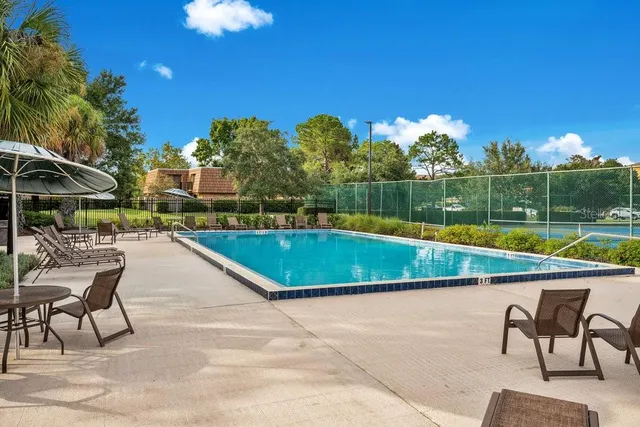 a view of swimming pool with a lounge chairs
