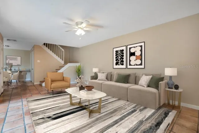 a living room with furniture and a chandelier