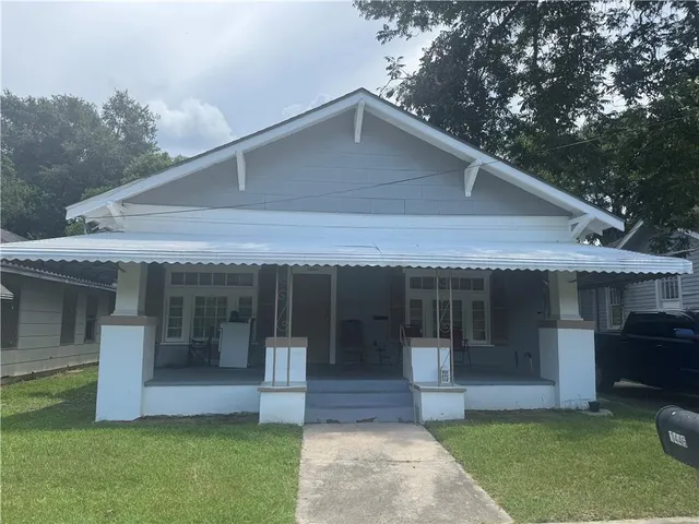 a front view of a house with a yard and porch